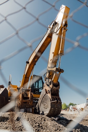 a large construction vehicle sitting on top of a dirt field