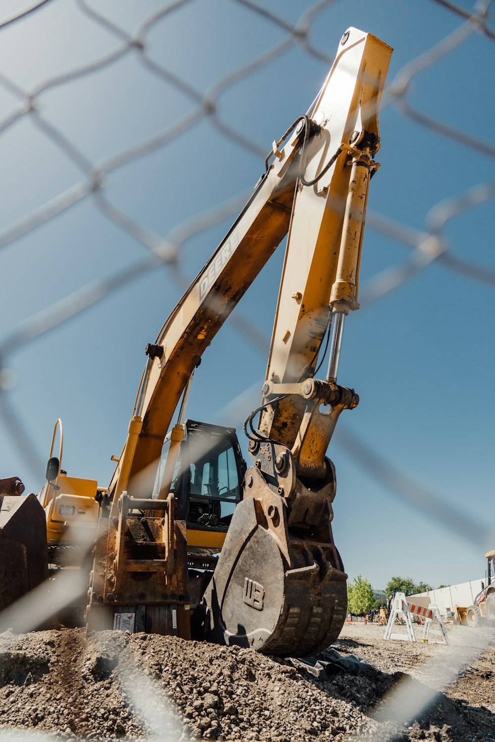 a large construction vehicle sitting on top of a dirt field