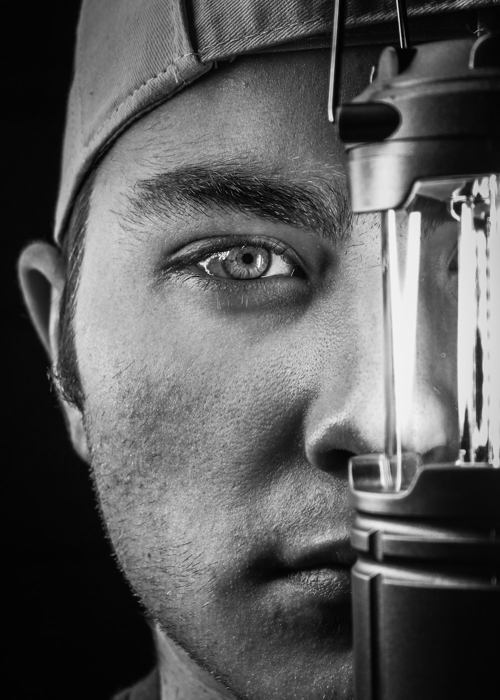 a black and white photo of a man with a light on his head