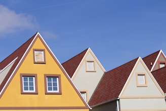 a row of houses with a blue sky in the background