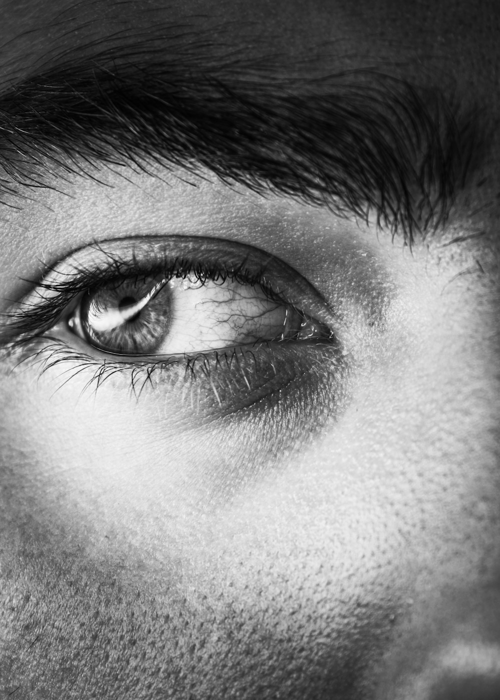 a black and white photo of a man's eye