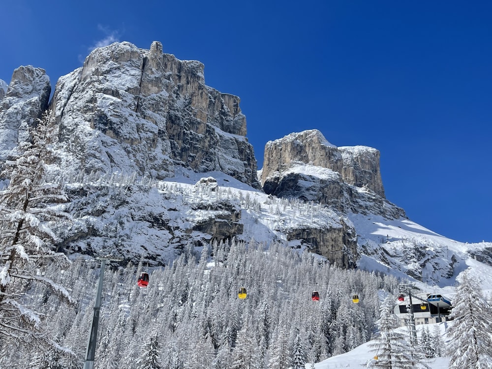 a snow covered mountain with a ski lift in the foreground