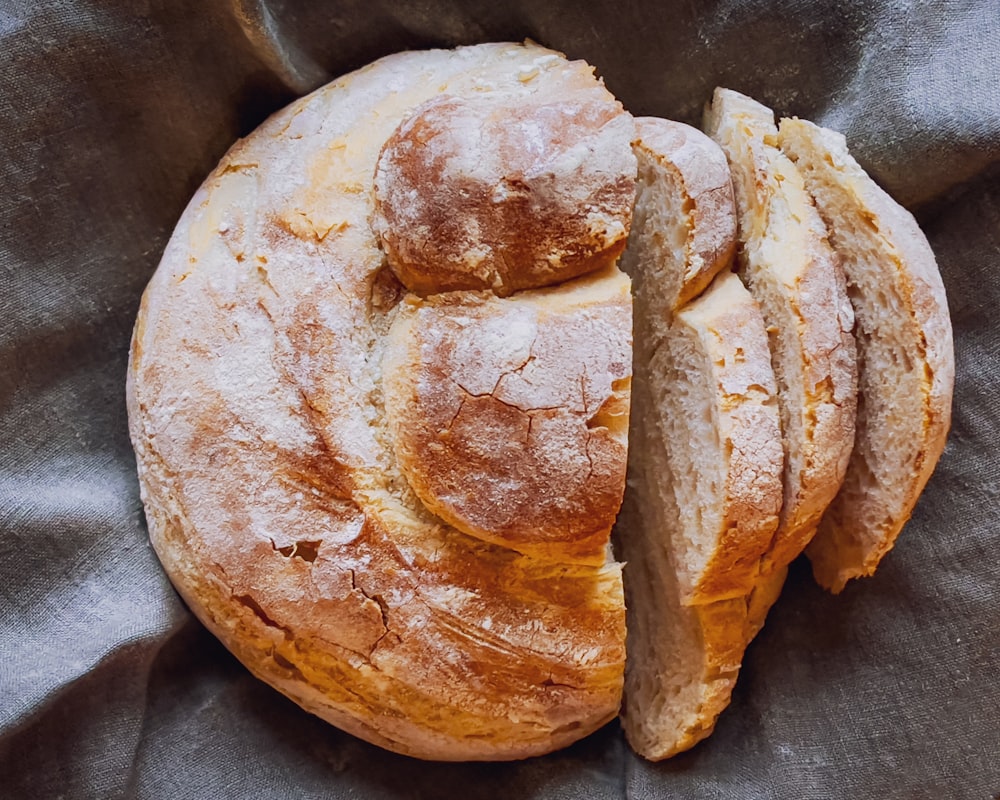 a round loaf of bread sitting on top of a cloth