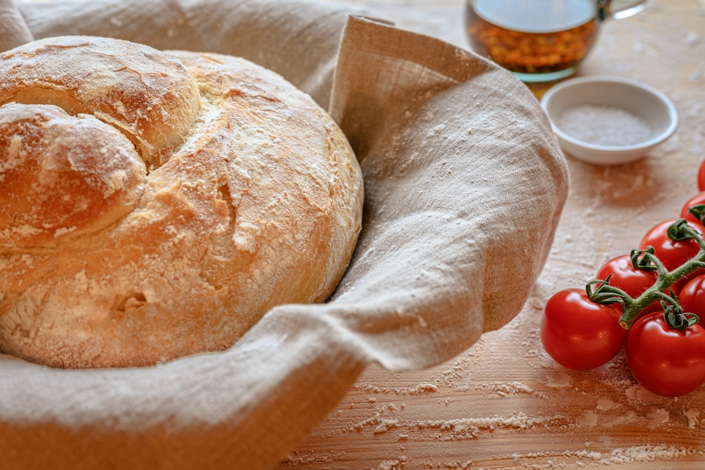 a loaf of bread sitting on top of a wooden table