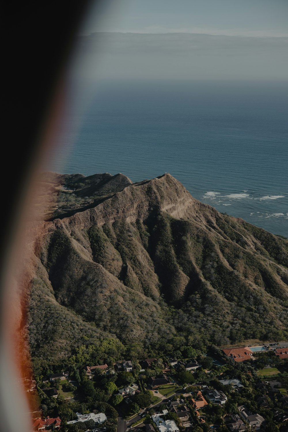 a view of a mountain with a body of water in the background