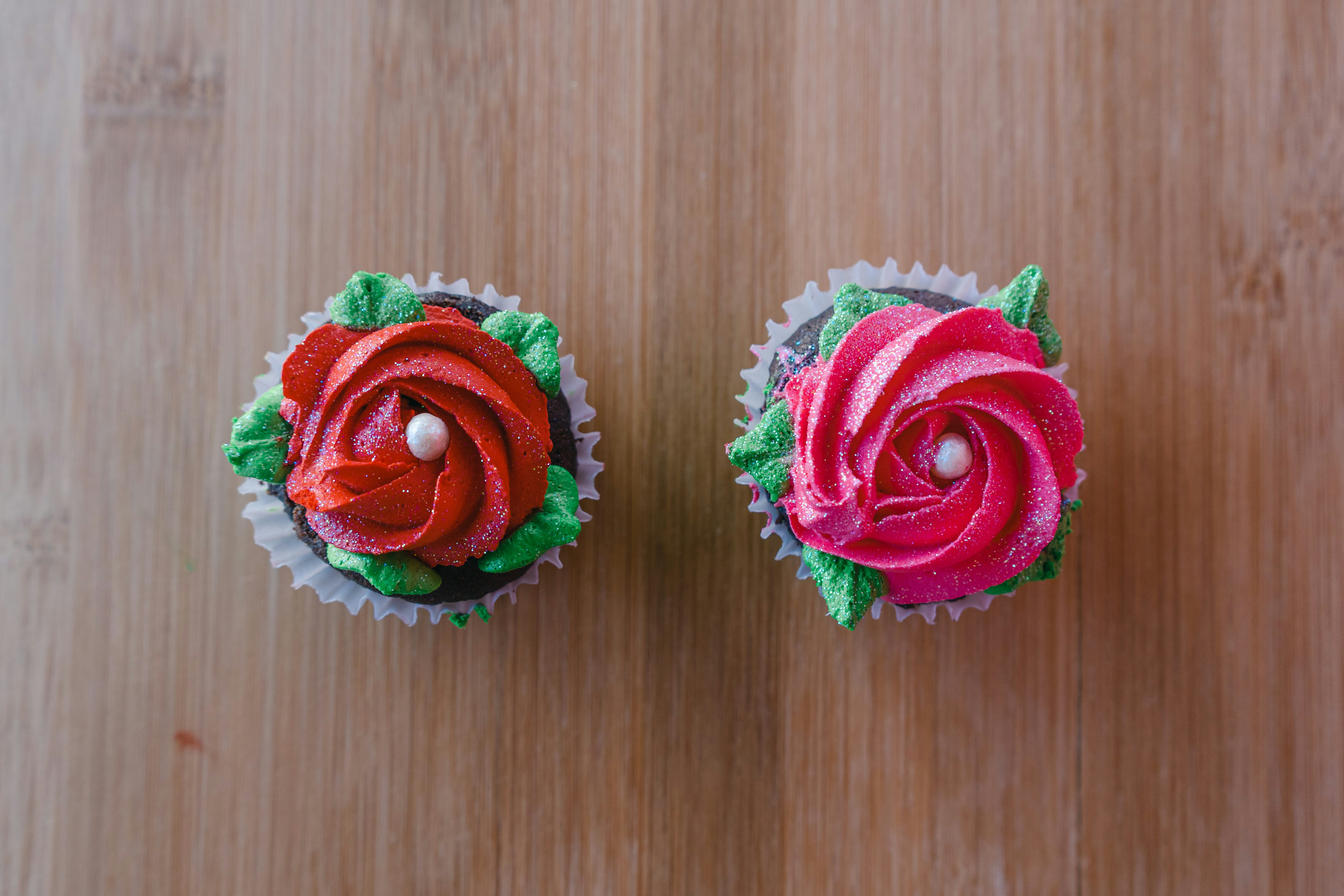 Two cupcakes with red and green frosting