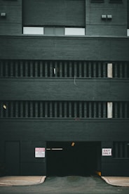 a black building with a sign on the side of it