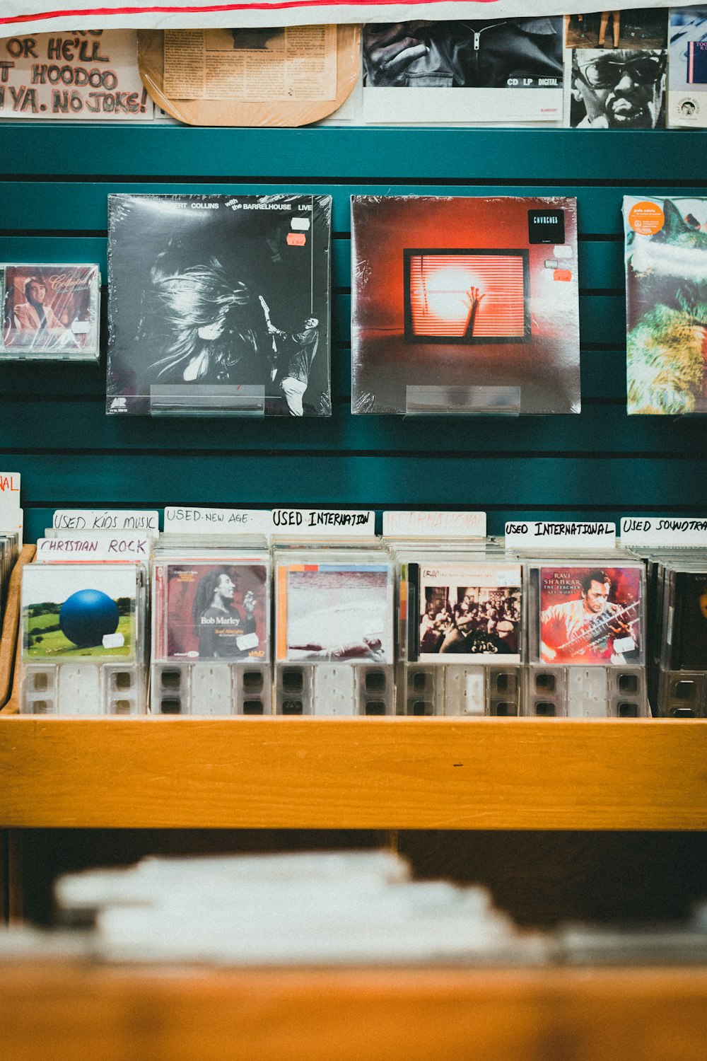 a wooden table topped with lots of cds