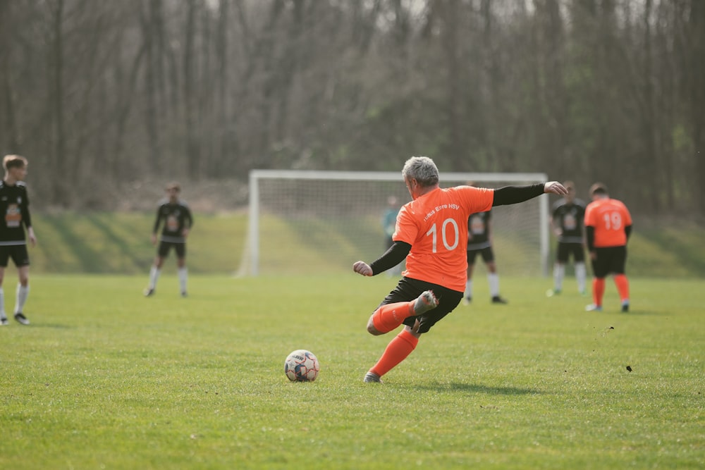 a man kicking a soccer ball on a field