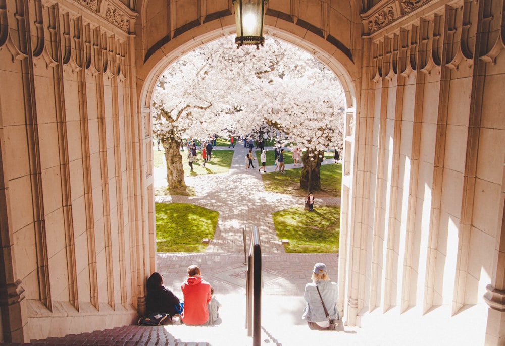 a group of people sitting on the steps of a building