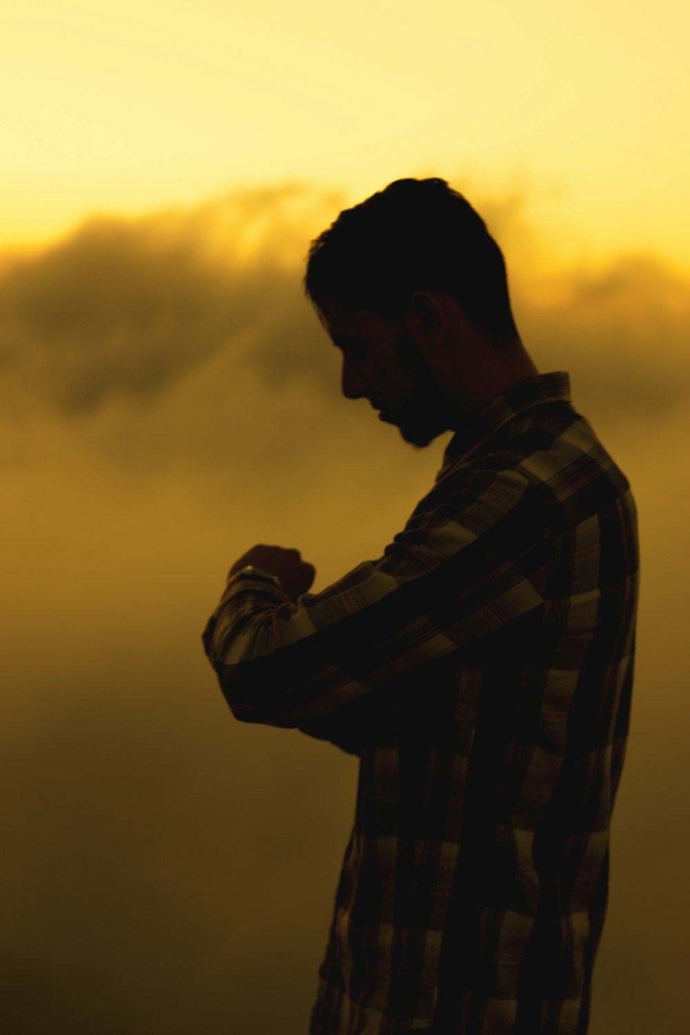 a man standing in front of a yellow sky