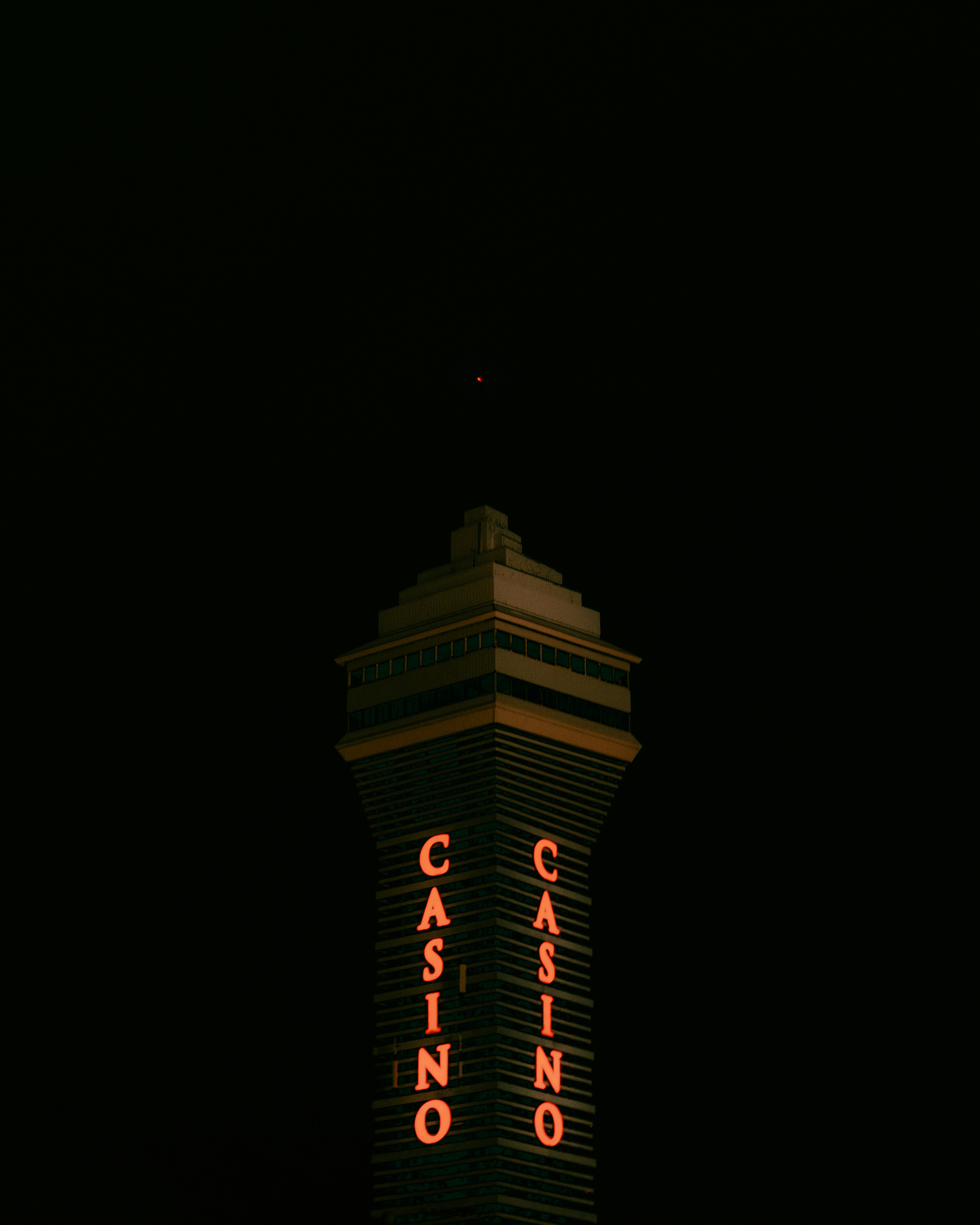 a casino sign lit up at night in the dark