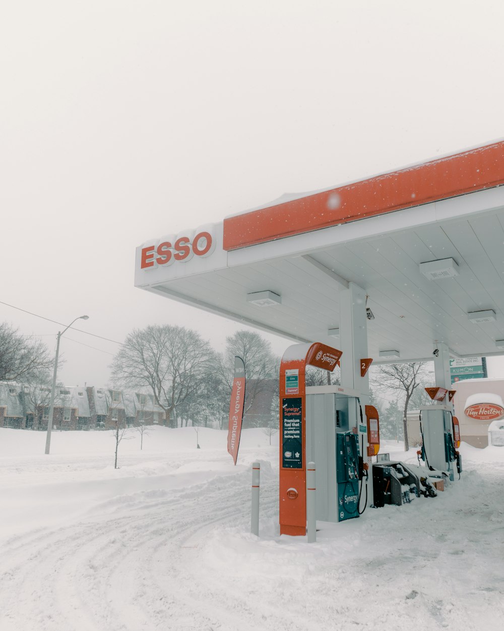 a red and white gas station in the snow