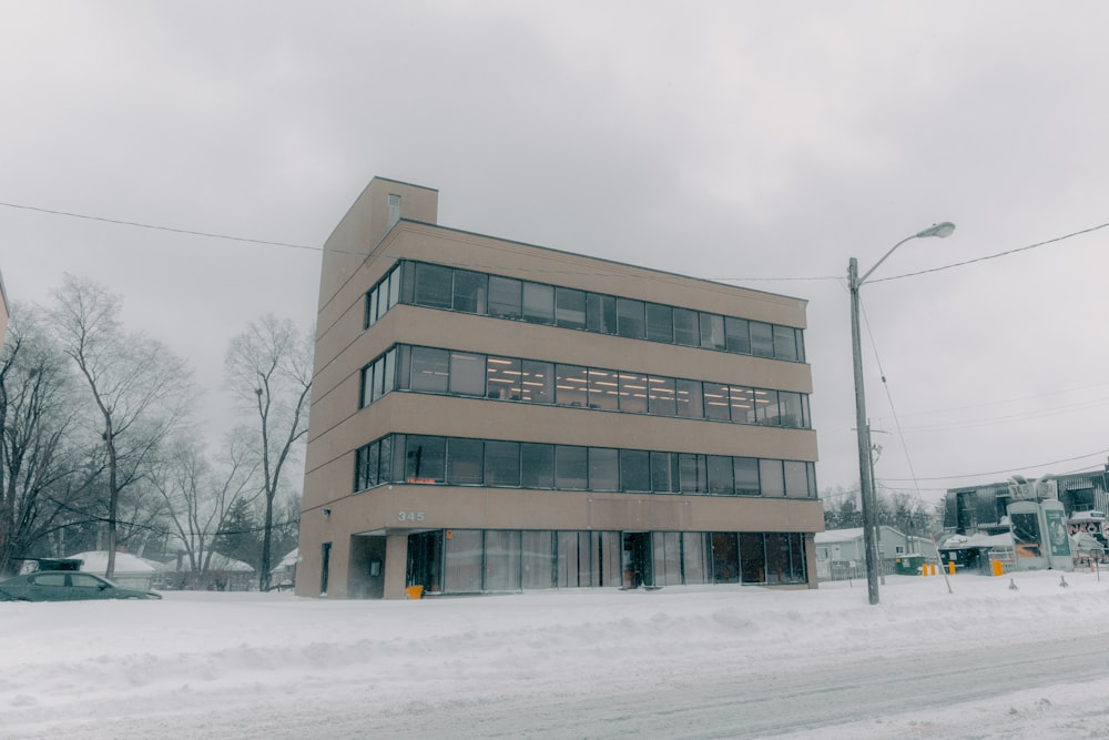 a large building sitting on the side of a snow covered road