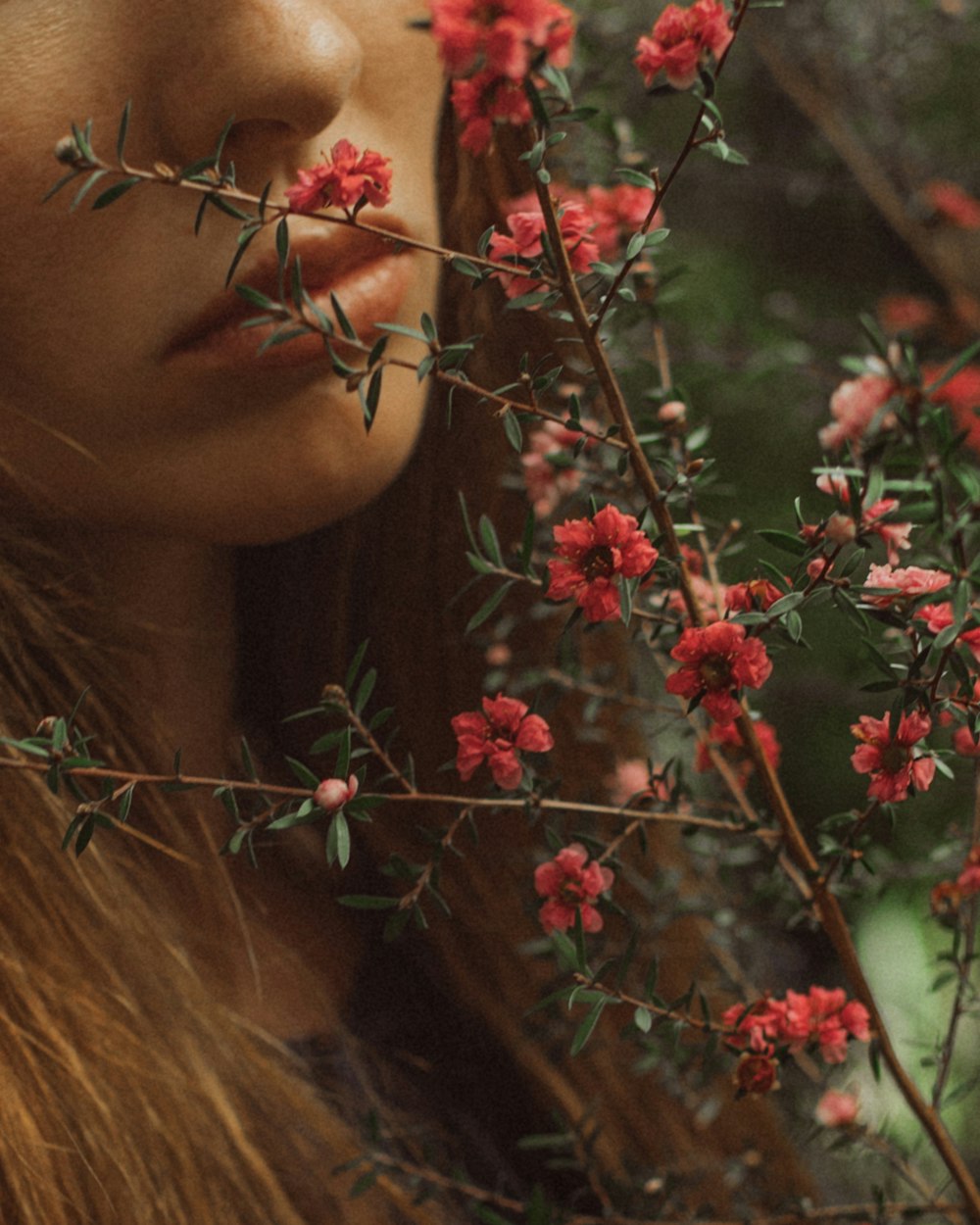 a woman with red flowers in her hair