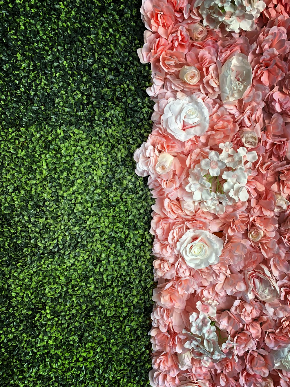 a green wall with pink and white flowers on it