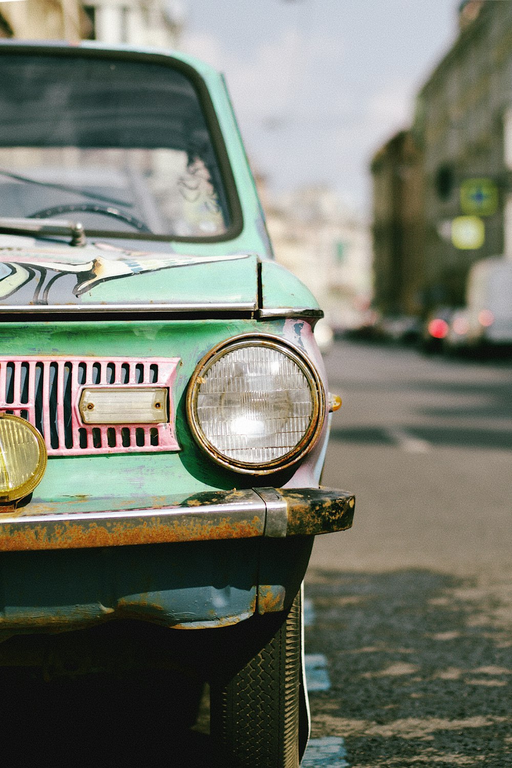 a green car parked on the side of the road