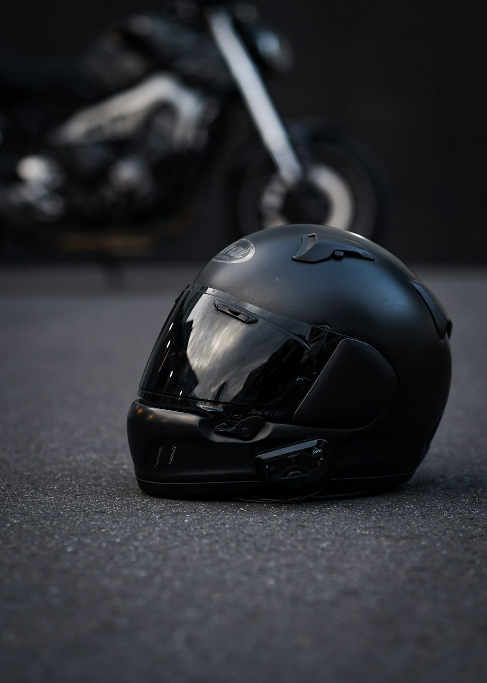 a helmet on the ground next to a motorcycle