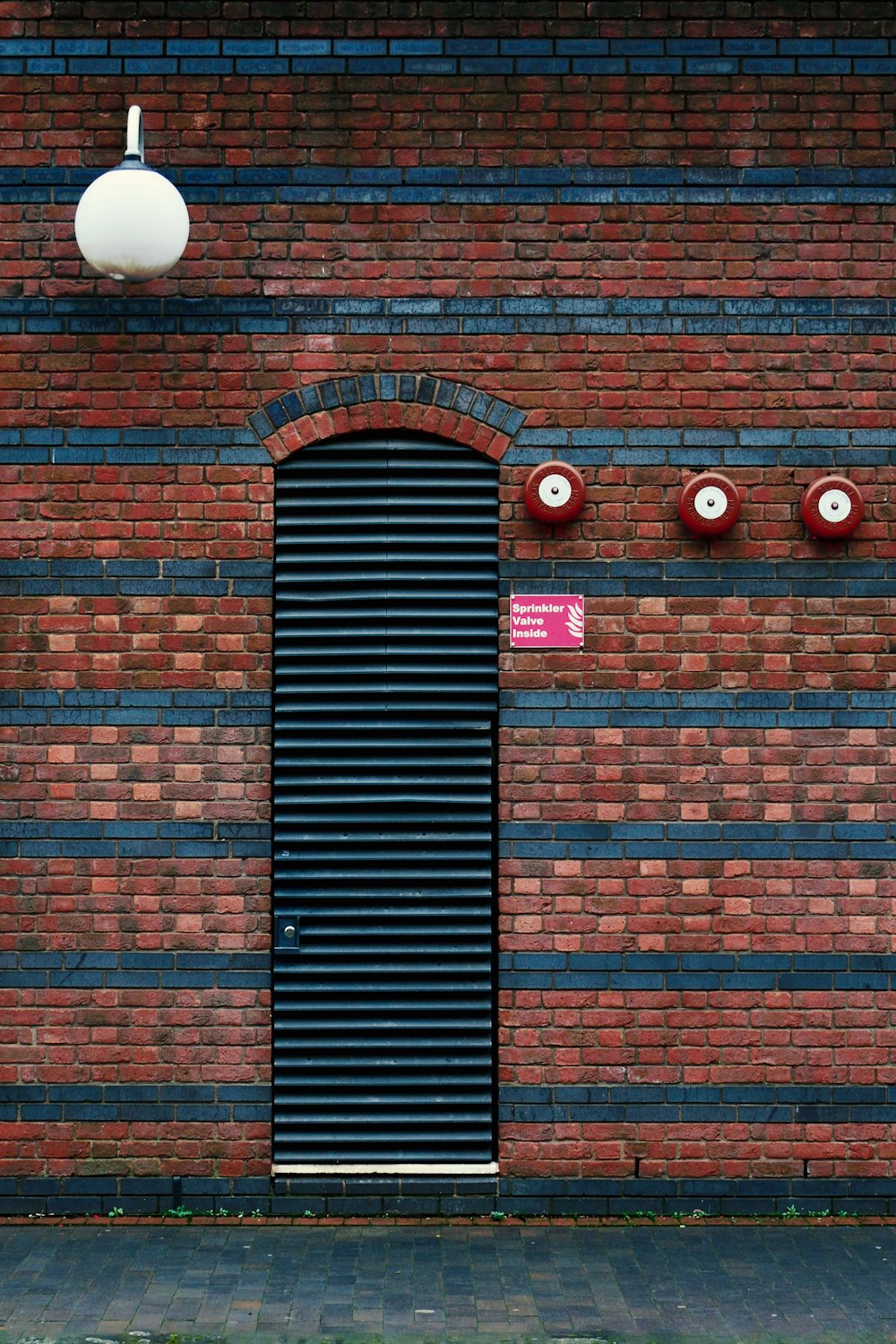 a red brick building with a black door