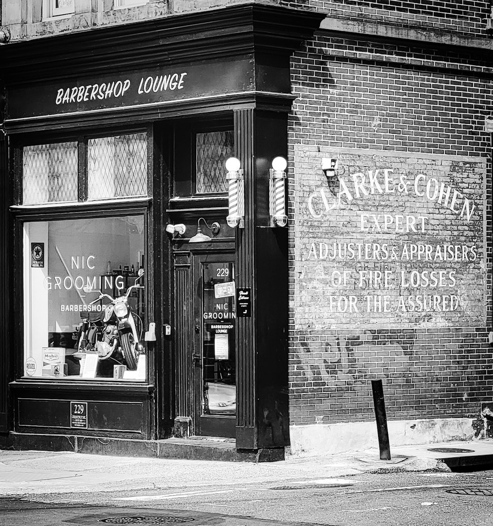 a black and white photo of a barbershop