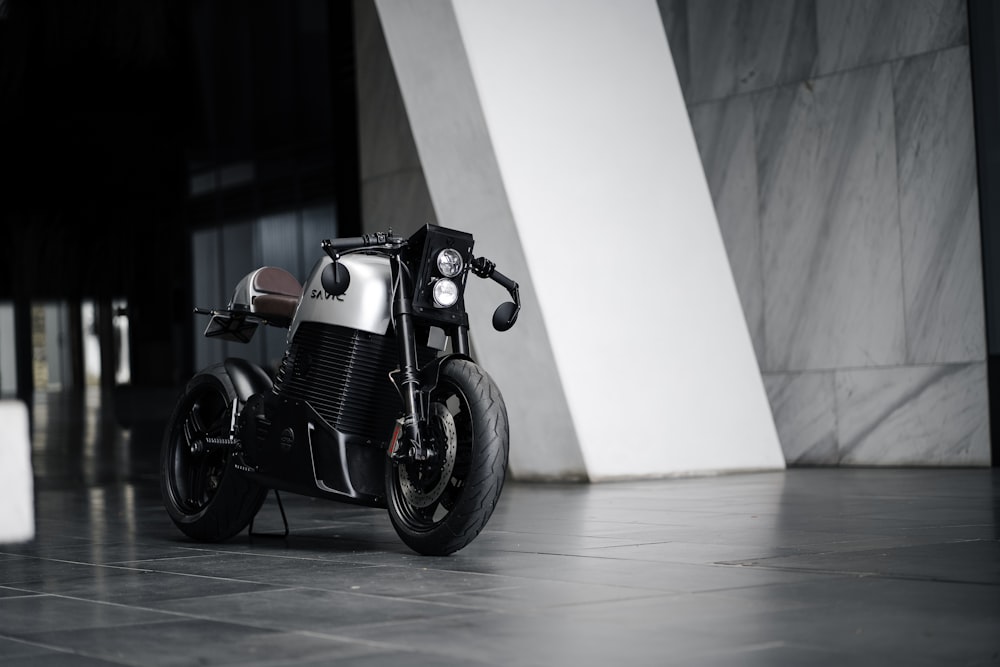 a black and silver motorcycle parked in front of a building