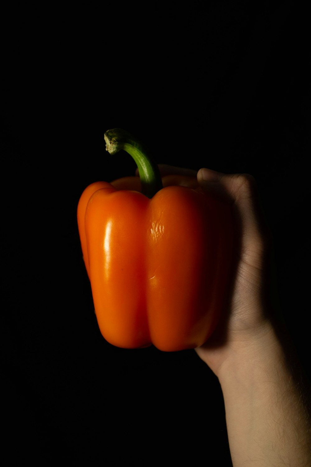 a person holding a pepper in their hand