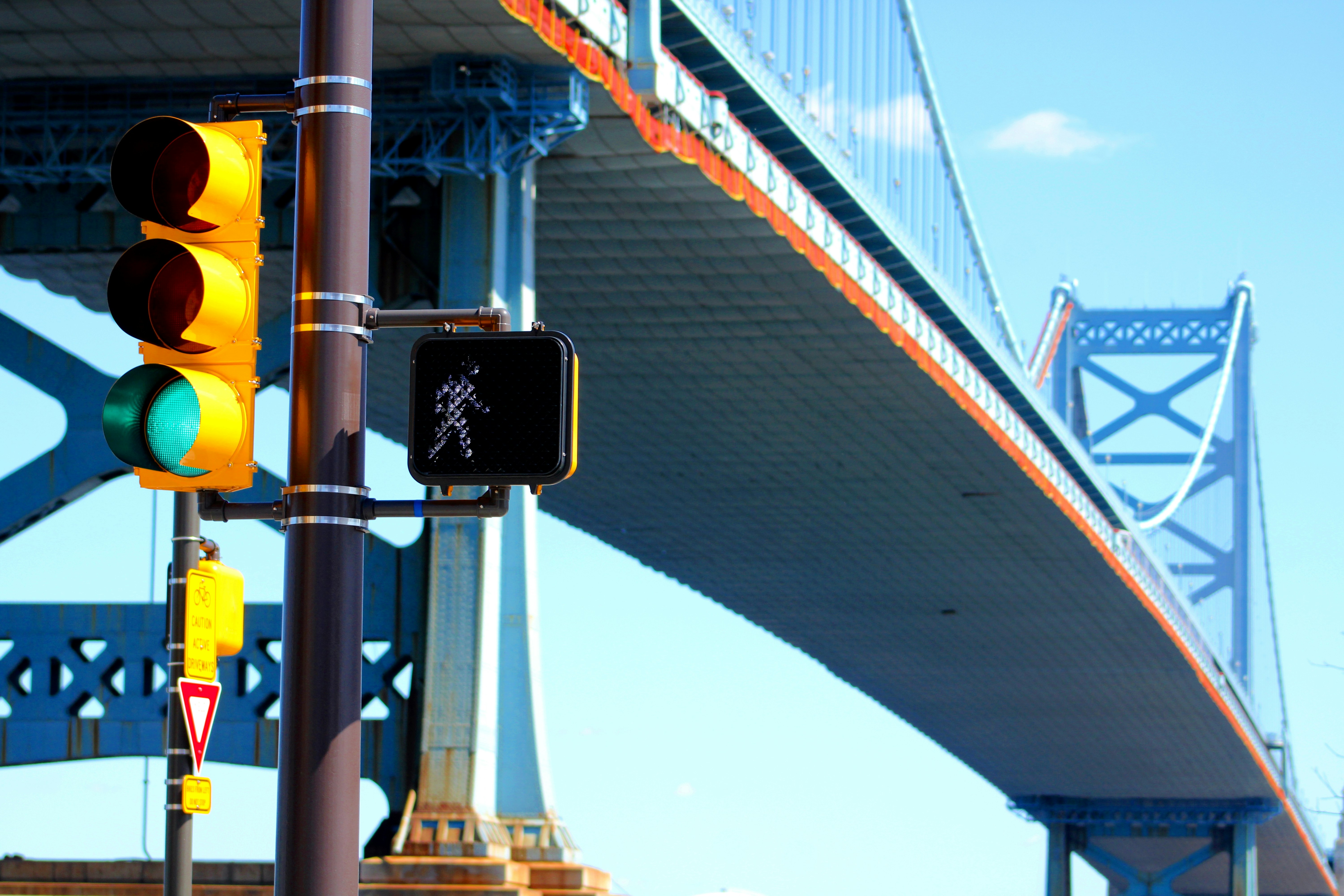 a traffic light with a bridge in the background