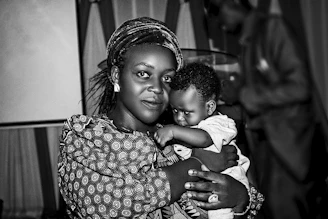 a woman holding a baby in her arms