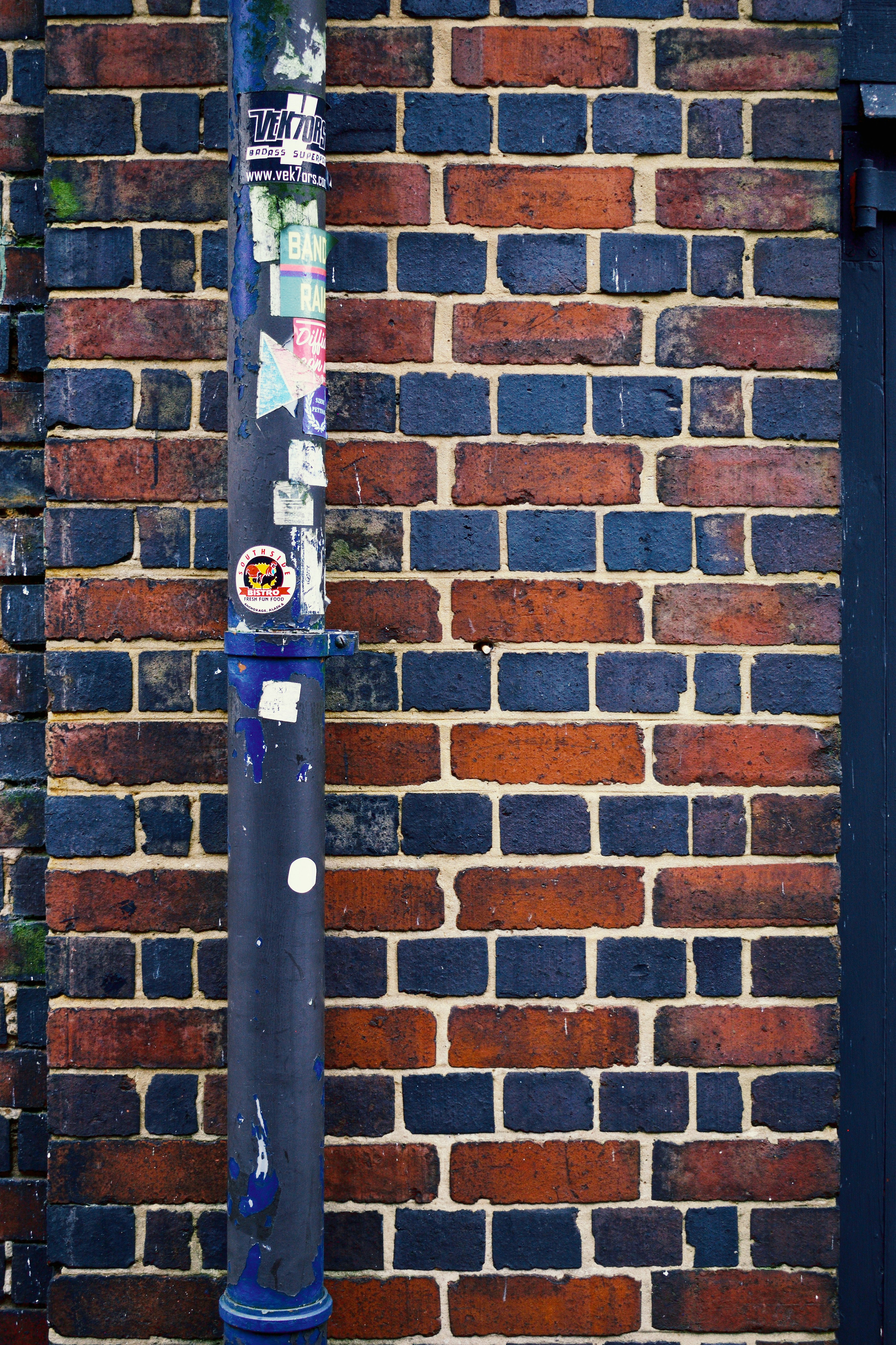 a baseball bat leaning against a brick wall