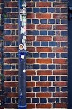 a baseball bat leaning against a brick wall