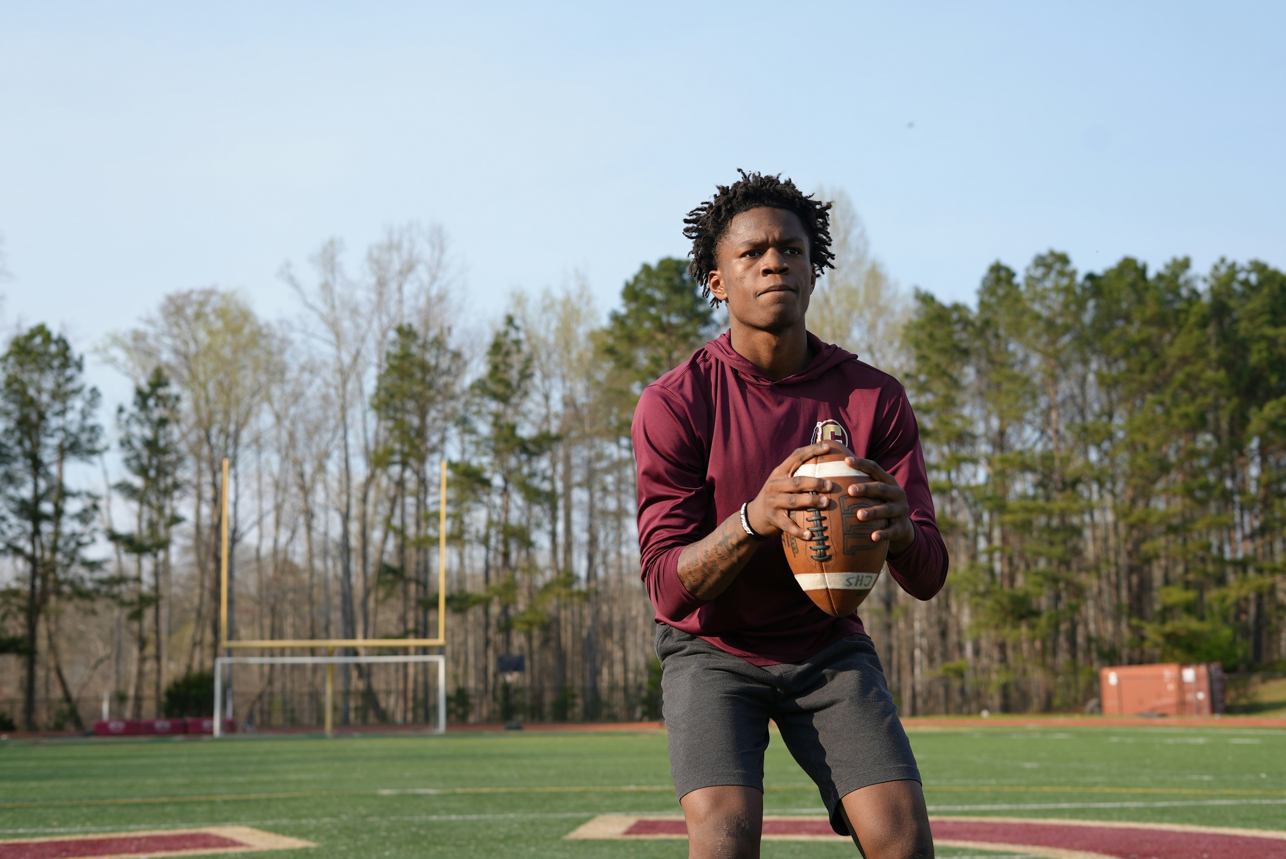 a man holding a football on a field