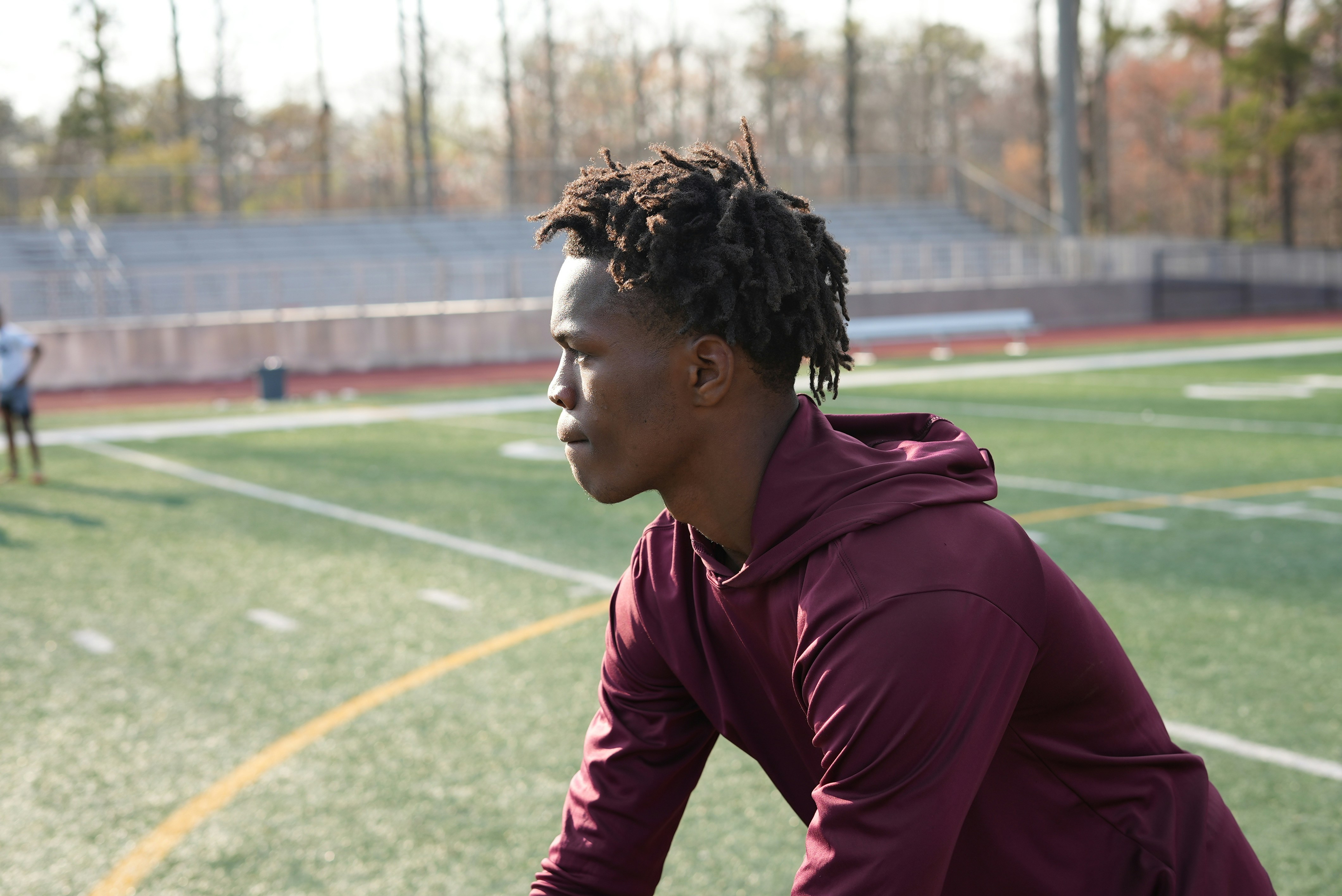 a man with dreadlocks on a soccer field