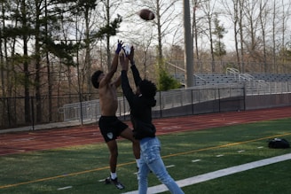 A Broncos player making a spectacular catch against a rival team.