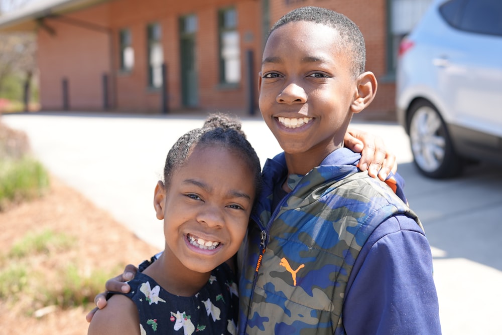 a couple of kids standing next to each other