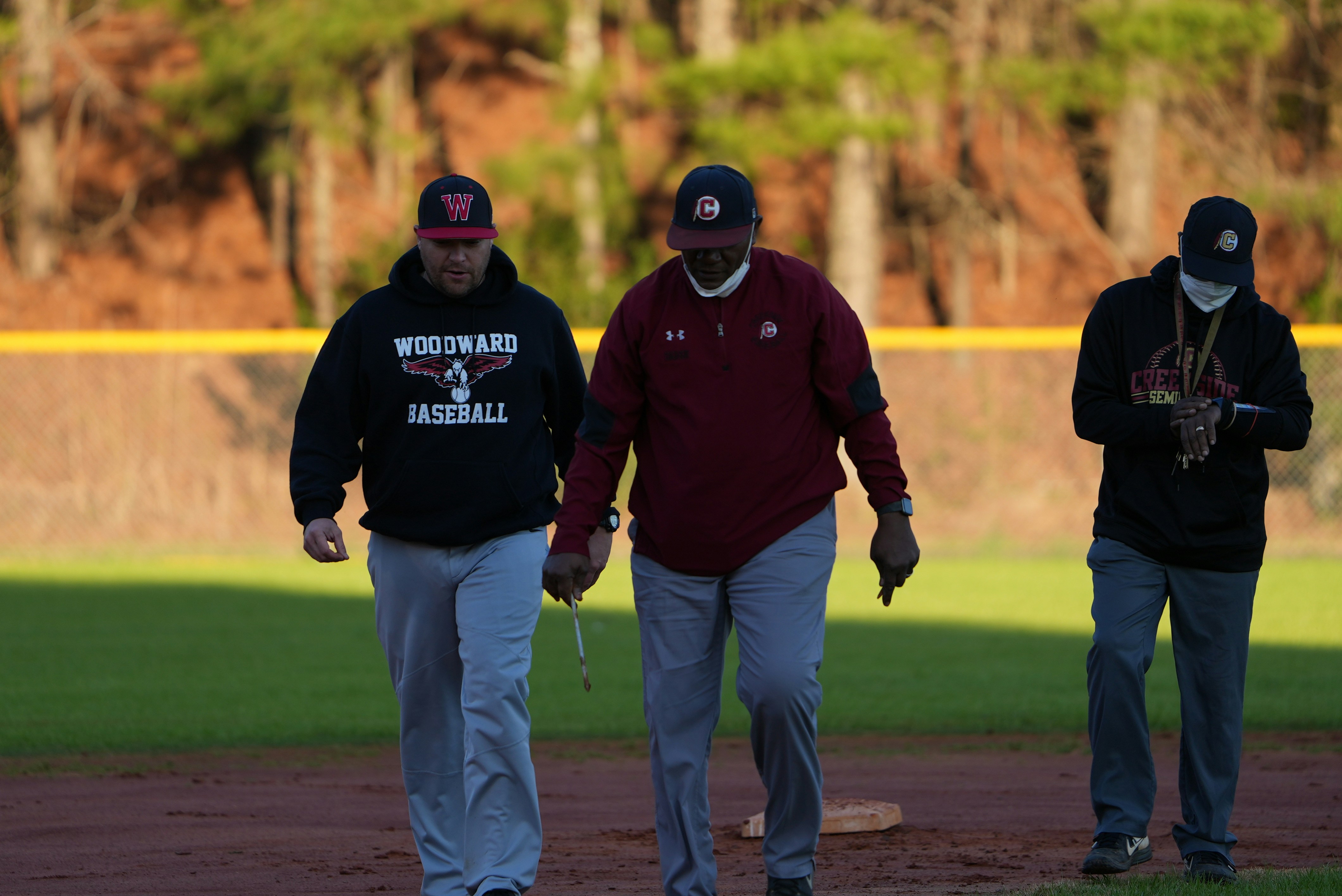 a group of men walking across a baseball field