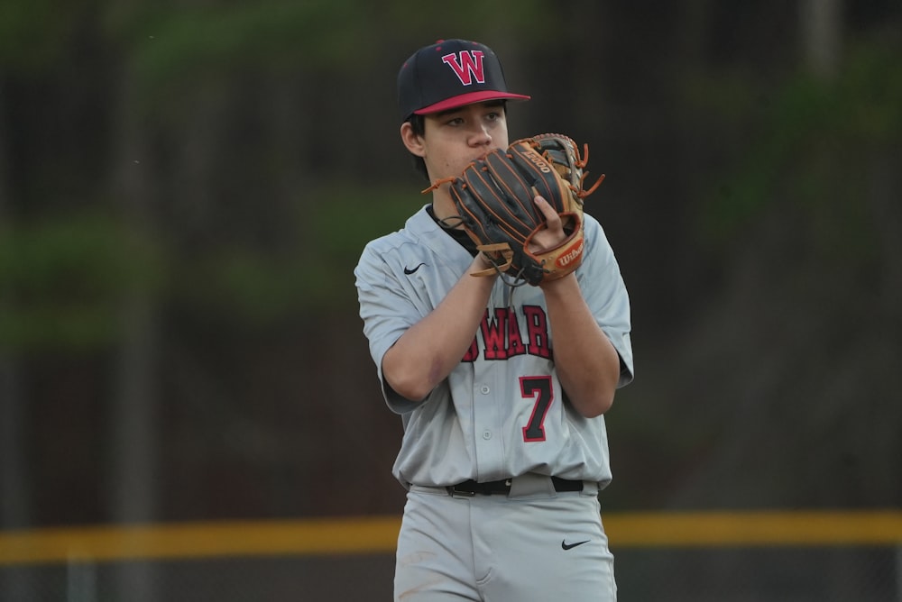 a baseball player holding a catchers mitt on a field