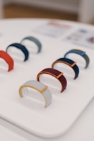 An assortment of colorful wrist guards arranged neatly on a gym floor.