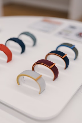 Variety of knee braces in different colors and styles displayed on a wooden table.