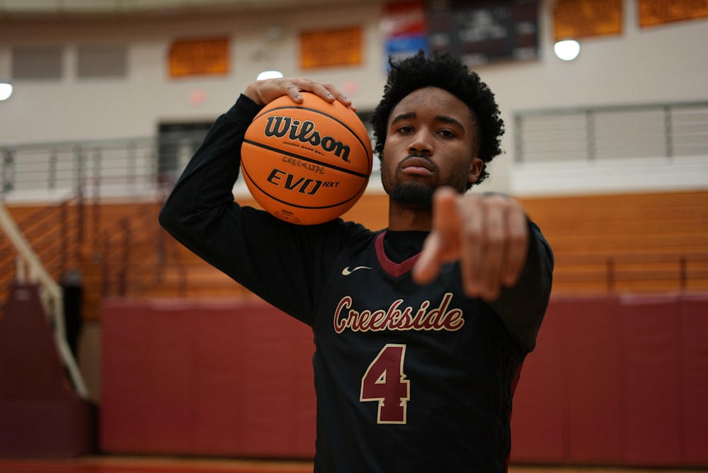 a man holding a basketball in a gym