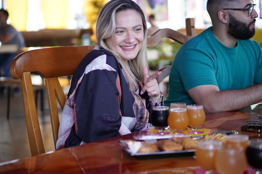 a man and a woman sitting at a table with drinks