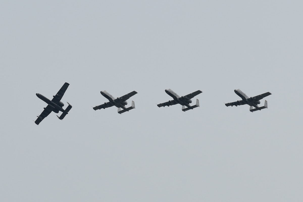 four airplanes flying in formation in the sky