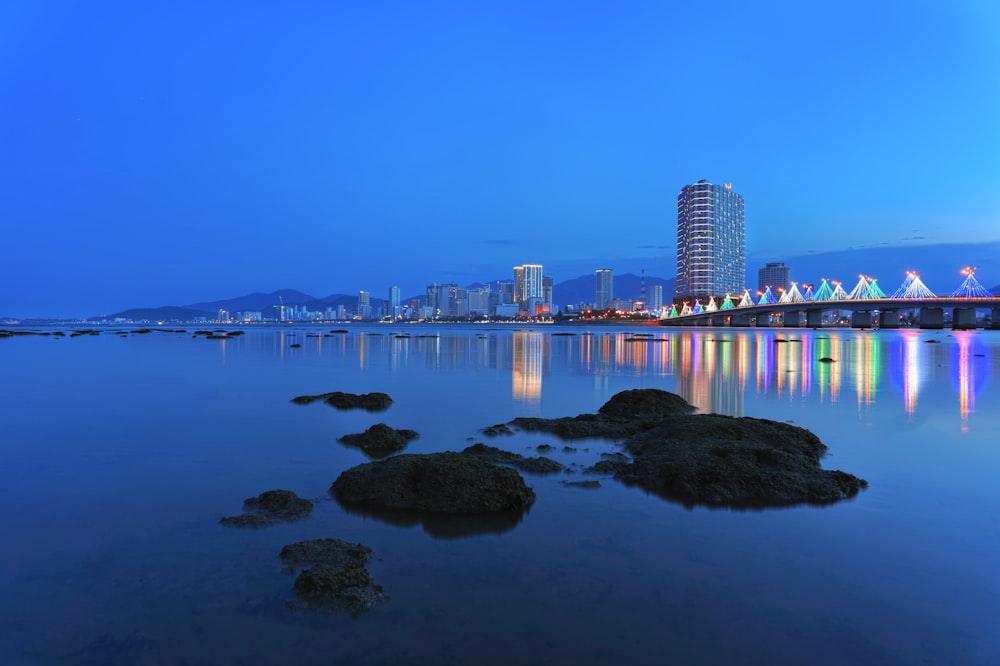 a large body of water with a bridge in the background