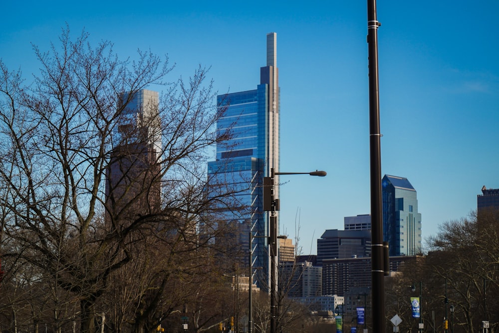 a city street with tall buildings in the background