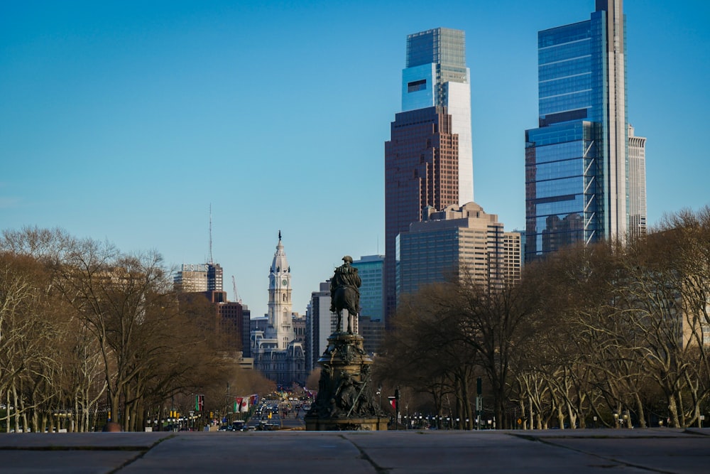 a city with tall buildings and a statue in the middle