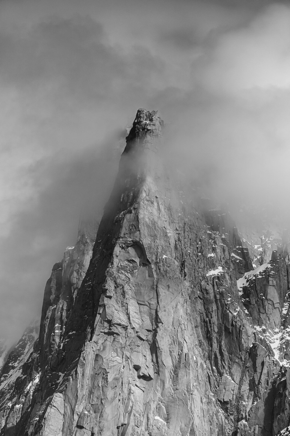 a very tall mountain covered in fog and clouds