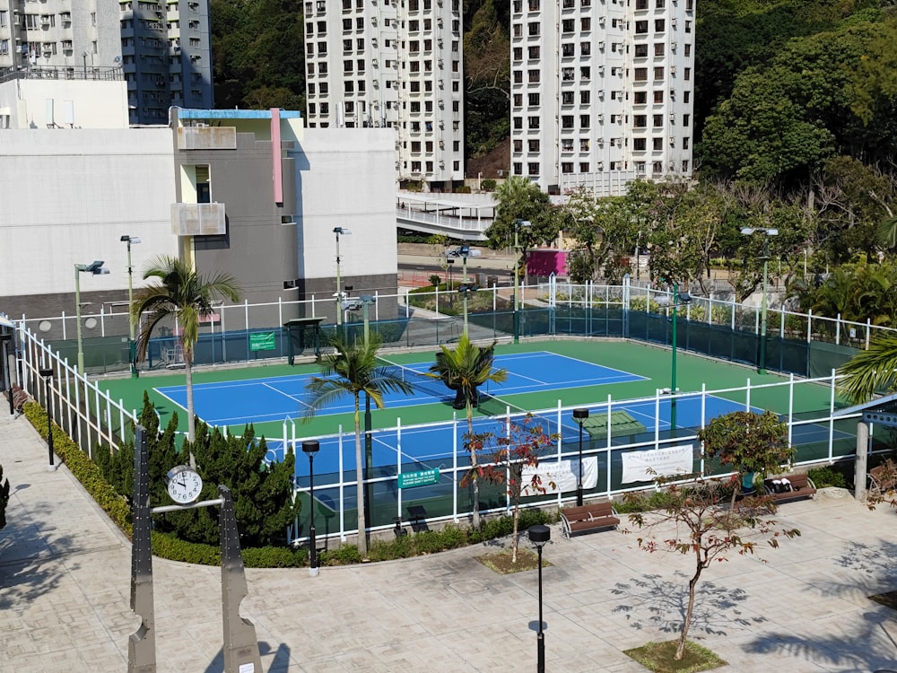 an aerial view of a tennis court in a city