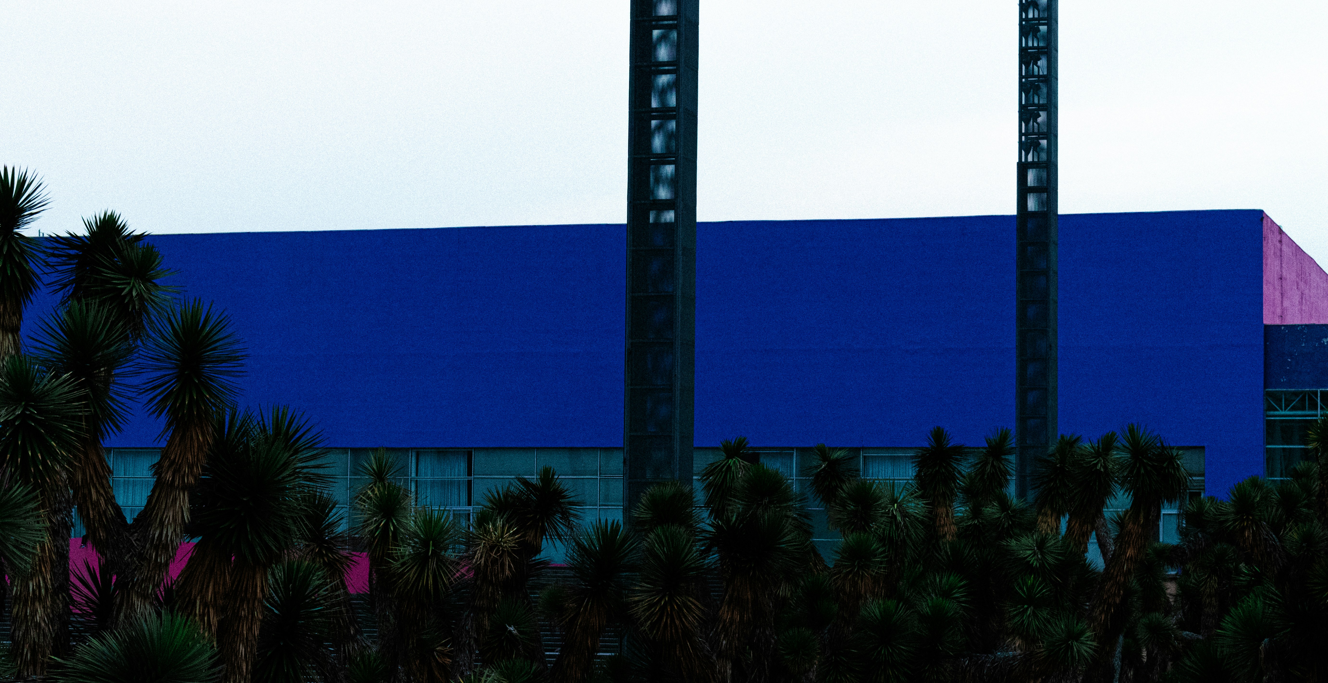 A generic photo of a textile factory building, possibly with a company logo blurred, to represent the setting.