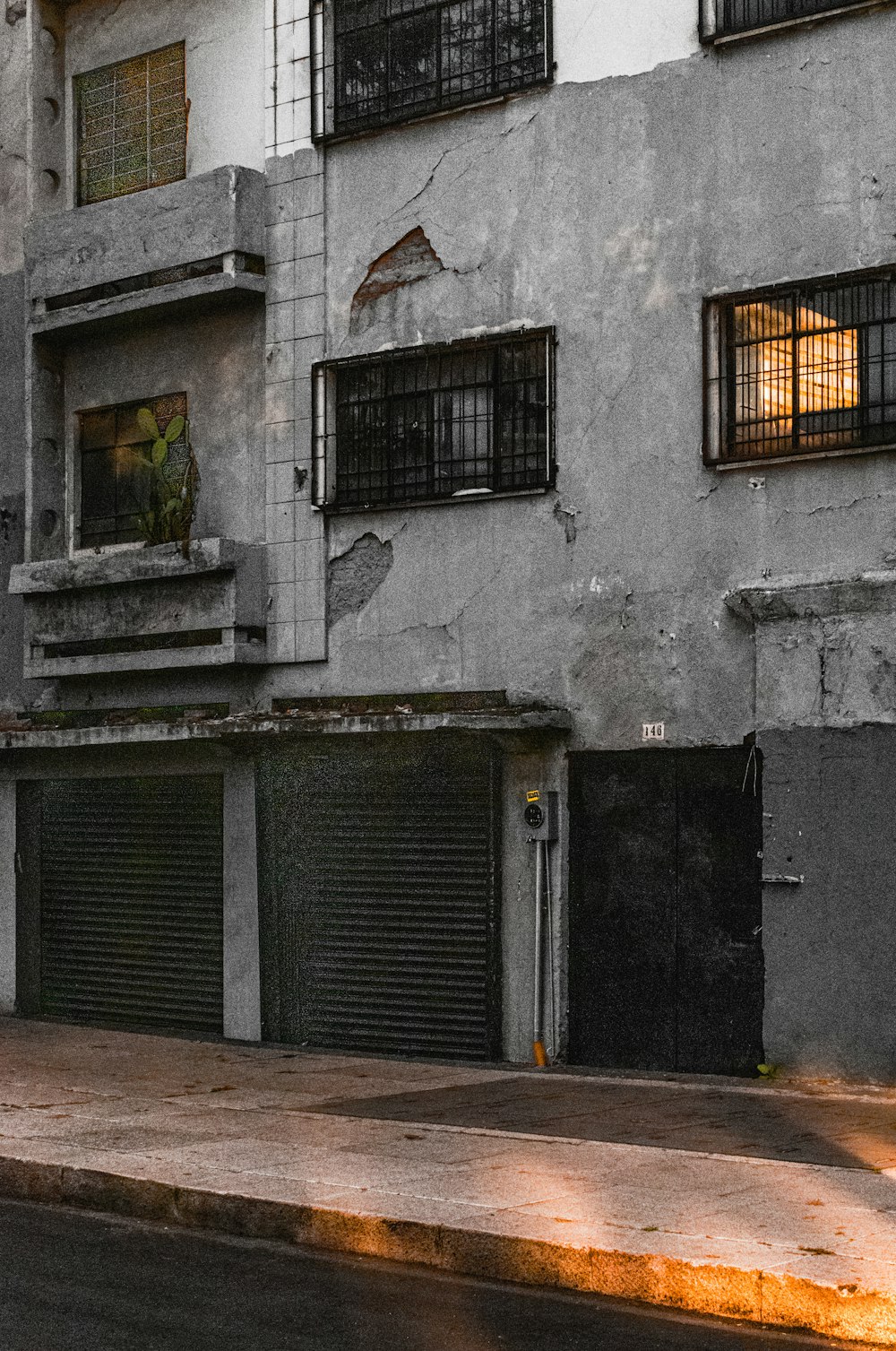 a man riding a skateboard down a street next to a tall building