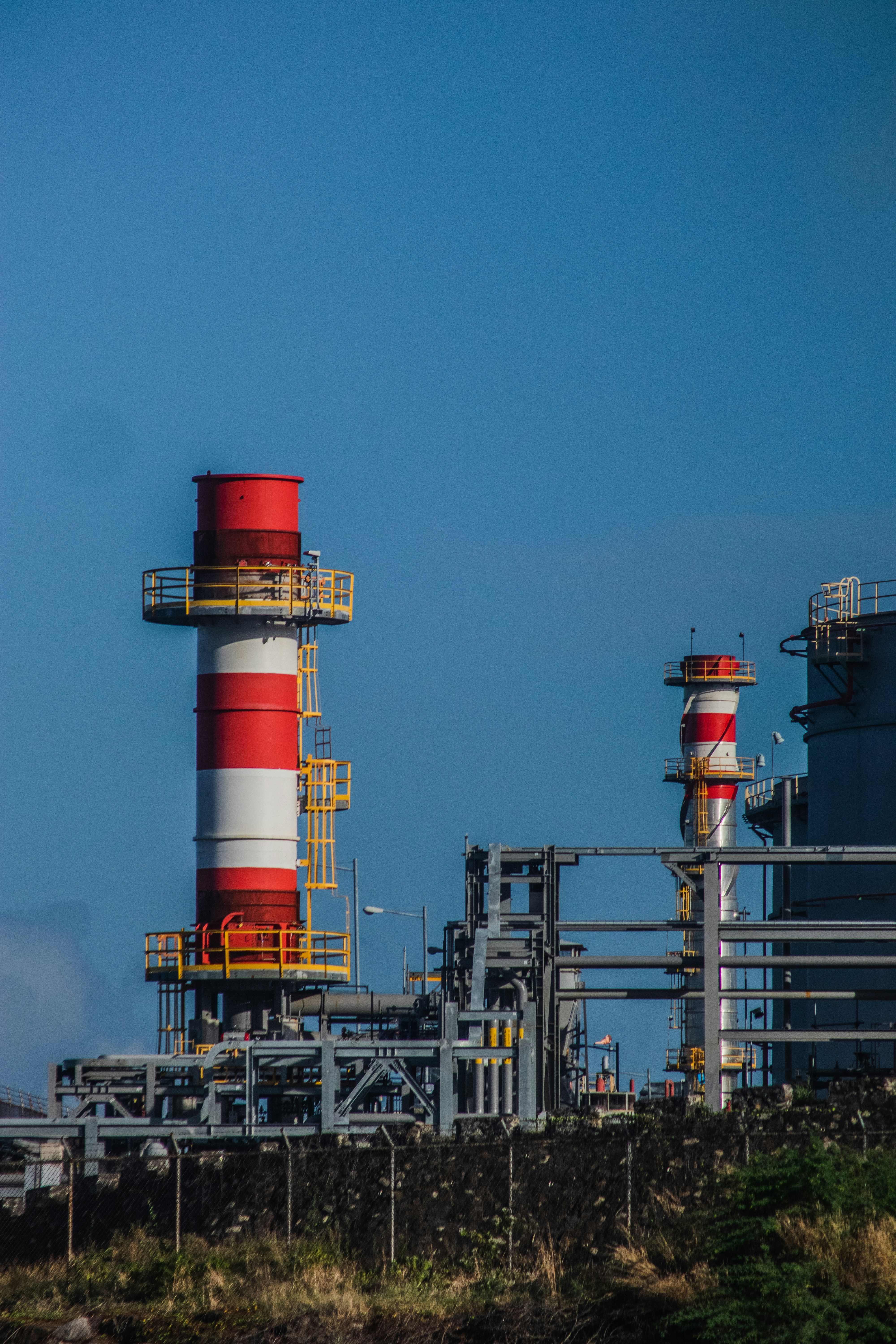 a large red and white tower next to a building