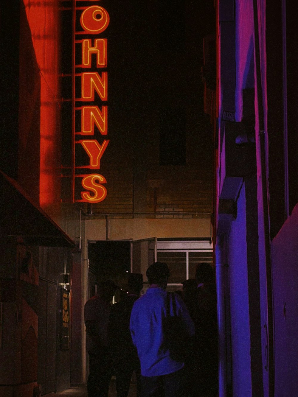 a group of people standing outside of a building